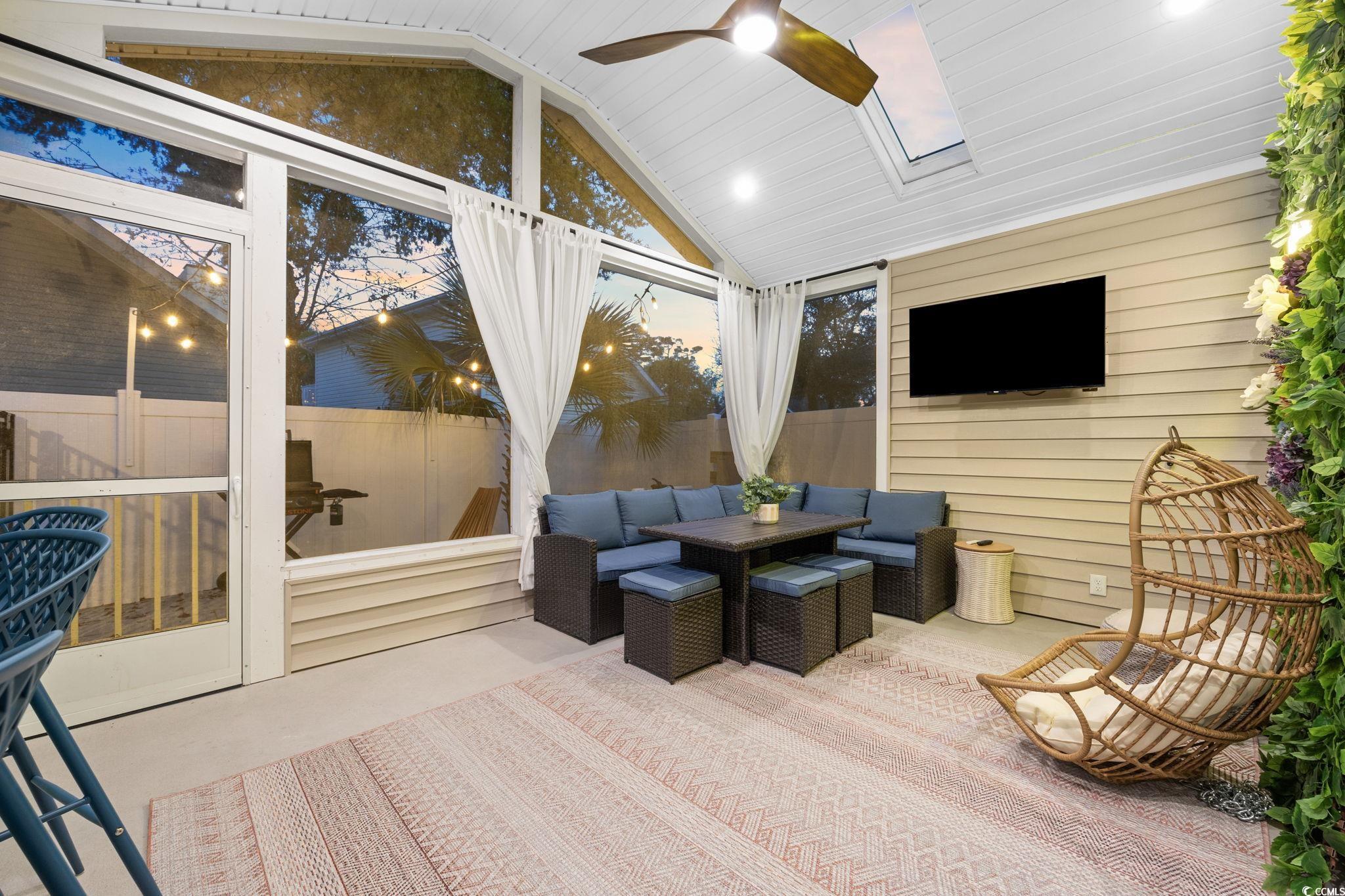 104 Ash Street North Myrtle Beach, SC 29582 - Photo 29 of 39 Sunroom / solarium featuring a skylight, recessed lighting, high vaulted ceiling, concrete floors, and wood walls