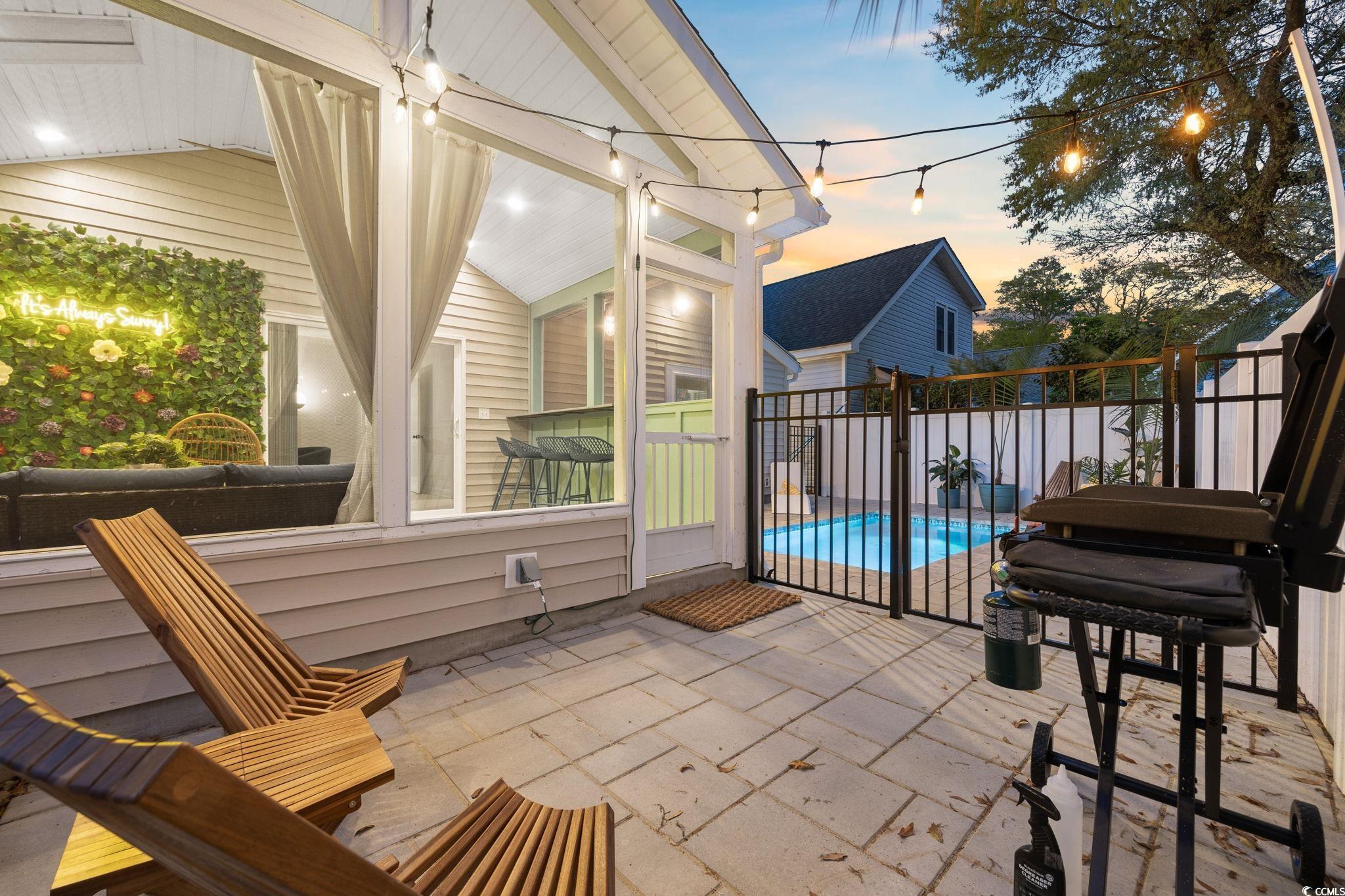 104 Ash Street North Myrtle Beach, SC 29582 - Photo 31 of 39 Patio terrace at dusk with a patio area and a sunroom
