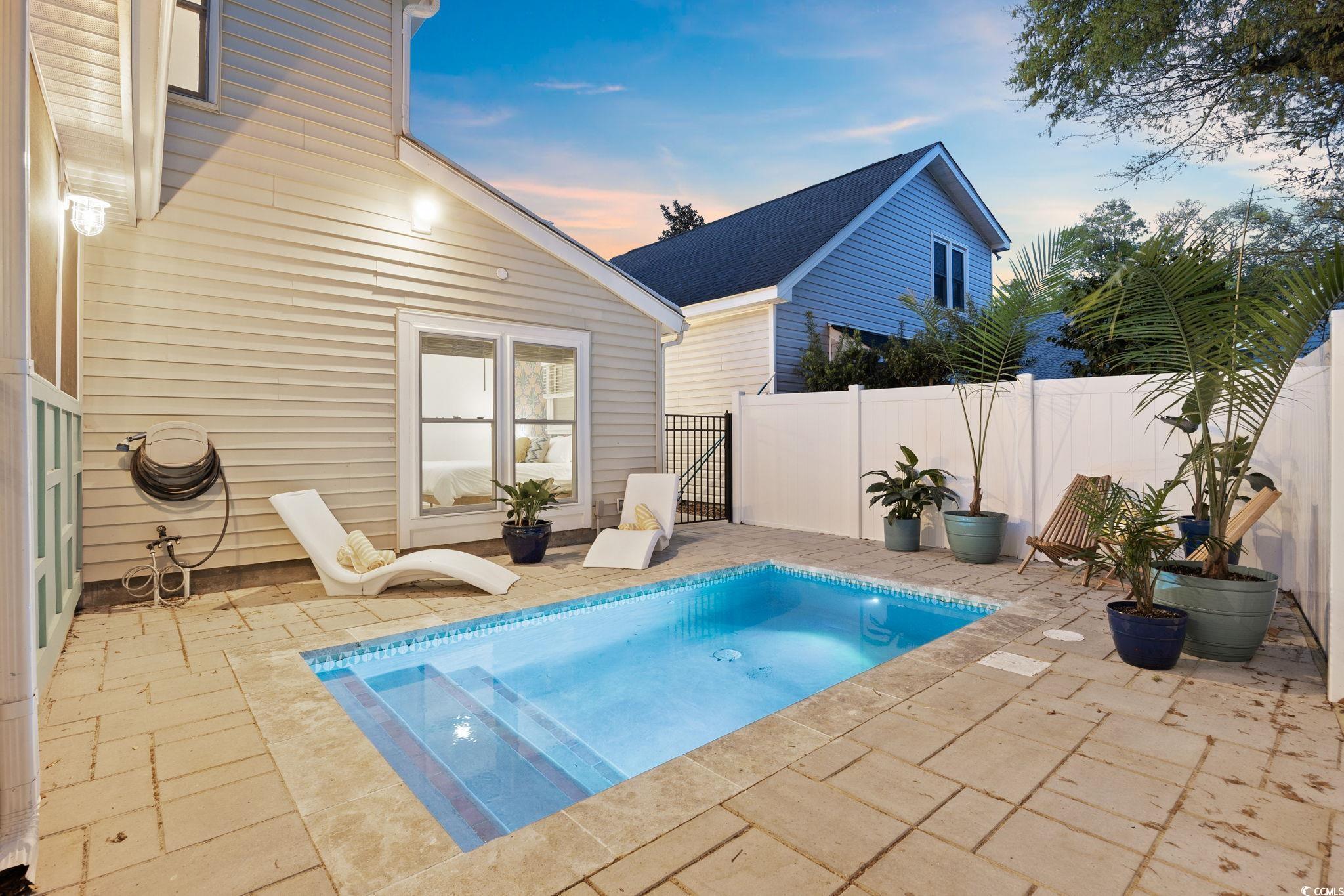 104 Ash Street North Myrtle Beach, SC 29582 - Photo 32 of 39 Pool at dusk featuring a patio area