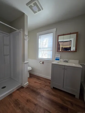a bathroom with a sink toilet and shower