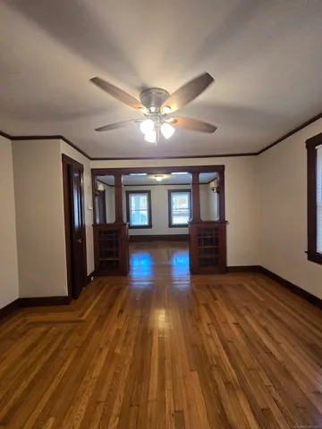 a view of empty room with wooden floor