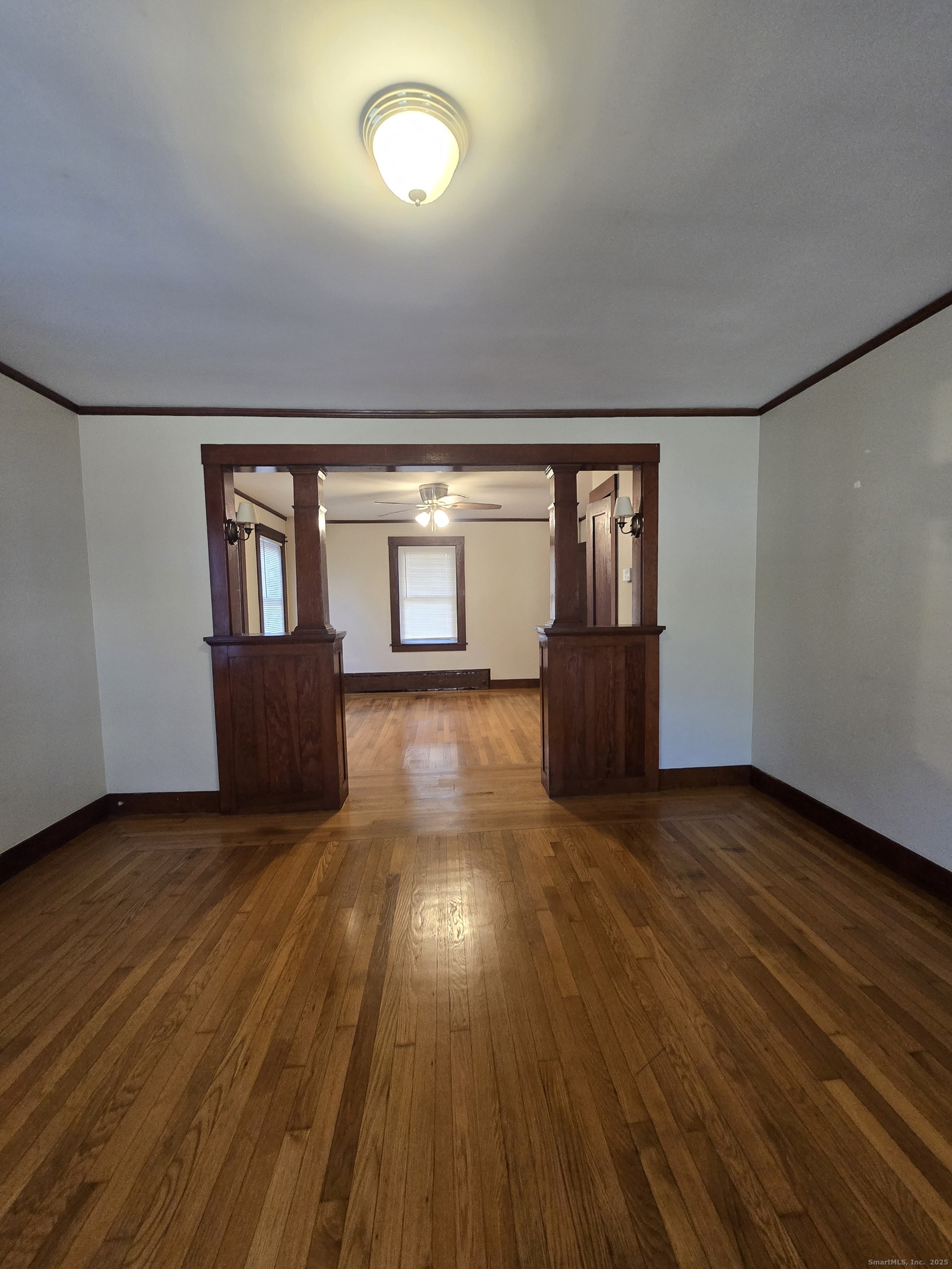 19 Downer Street Stonington, CT 06379 - Photo 5 of 13 an empty room with wooden floor and windows