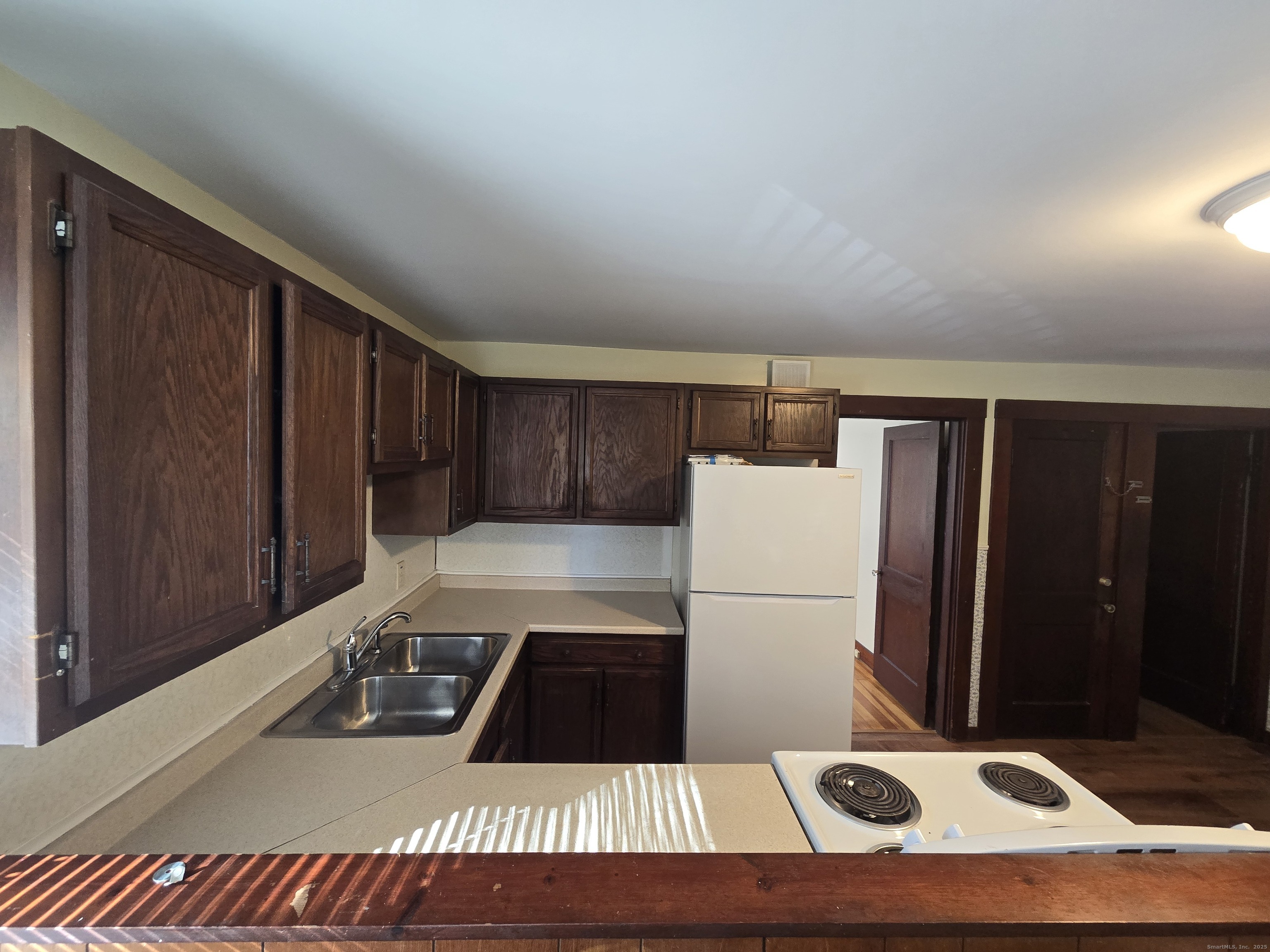 19 Downer Street Stonington, CT 06379 - Photo 6 of 13 a kitchen with a refrigerator and a stove