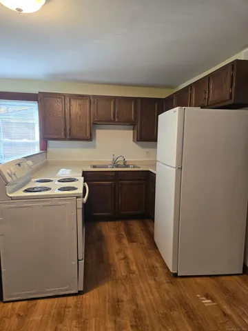 a kitchen with sink a refrigerator and a stove