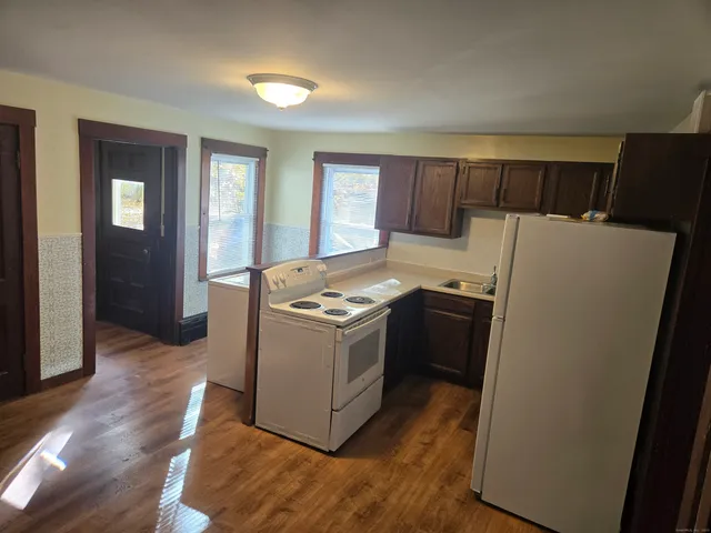 a kitchen with a stove a sink and a refrigerator