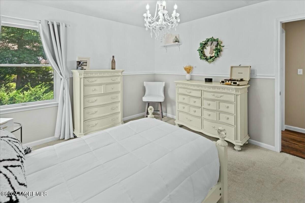 19 Popper Street Manahawkin, NJ 08050 - Photo 26 of 53 a bedroom with a bed and a table