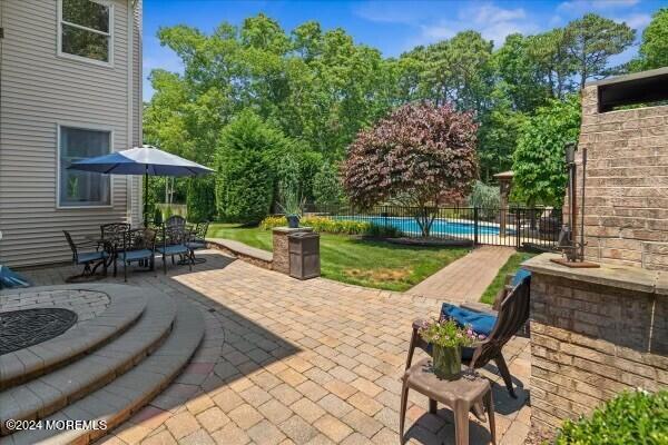 19 Popper Street Manahawkin, NJ 08050 - Photo 33 of 53 a view of a patio with table and chairs potted plants with wooden fence