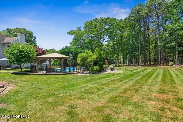 19 Popper Street Manahawkin, NJ 08050 - Photo 35 of 53 a view of a swimming pool with a garden