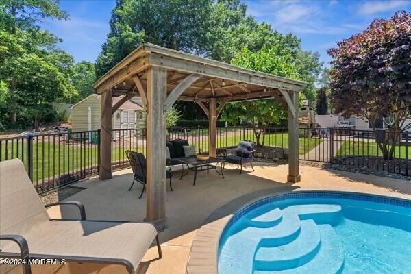 19 Popper Street Manahawkin, NJ 08050 - Photo 41 of 53 a view of a patio with a table chairs and a backyard