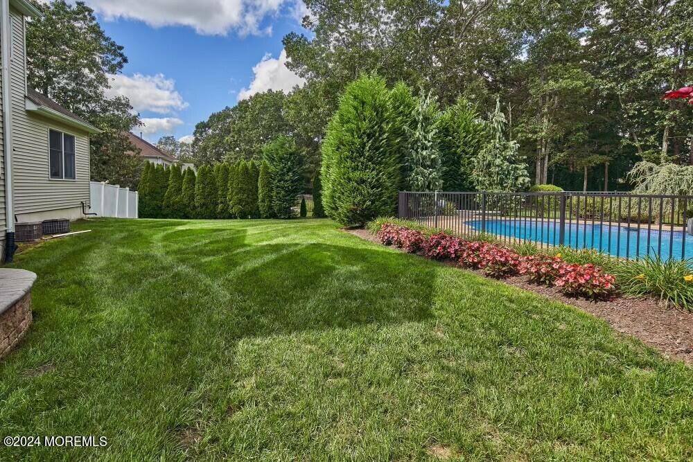 19 Popper Street Manahawkin, NJ 08050 - Photo 47 of 53 a view of a garden with flowers and trees