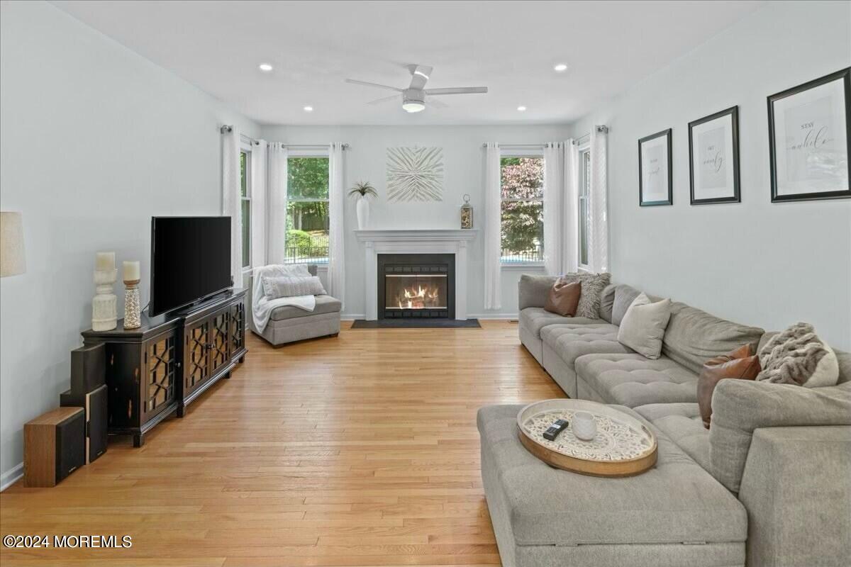 19 Popper Street Manahawkin, NJ 08050 - Photo 10 of 53 a living room with furniture a fireplace and a flat screen tv