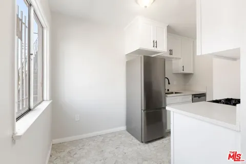 a kitchen with a refrigerator and a stove