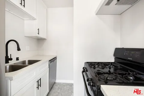 a kitchen with a stove and a sink