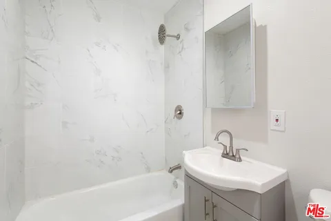 a bathroom with a sink and mirror