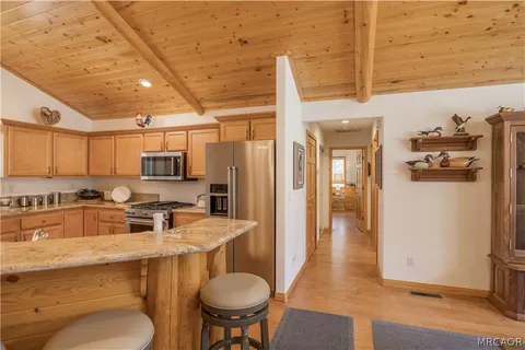 a kitchen with stainless steel appliances a stove a refrigerator and a sink