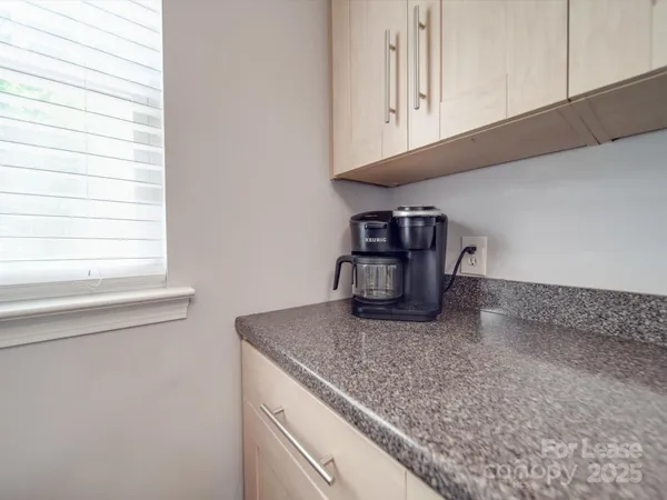 a kitchen with granite countertop stainless steel appliances a stove microwave and sink