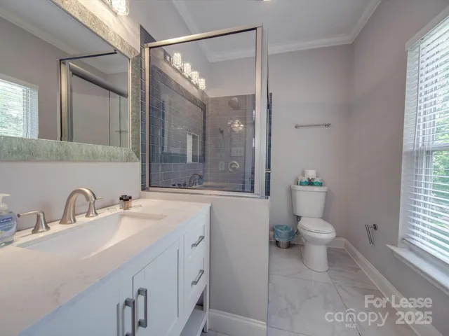 a large bed sitting in a bedroom next to a window