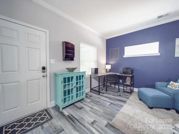 a view of entryway and hall with wooden floor
