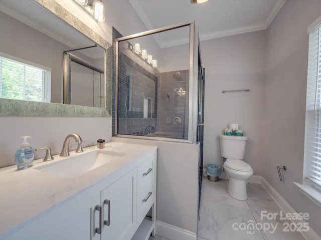 a white toilet sitting next to a bathroom sink