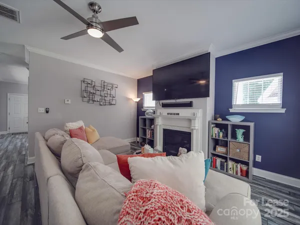 a living room with furniture a flat screen tv and a fireplace