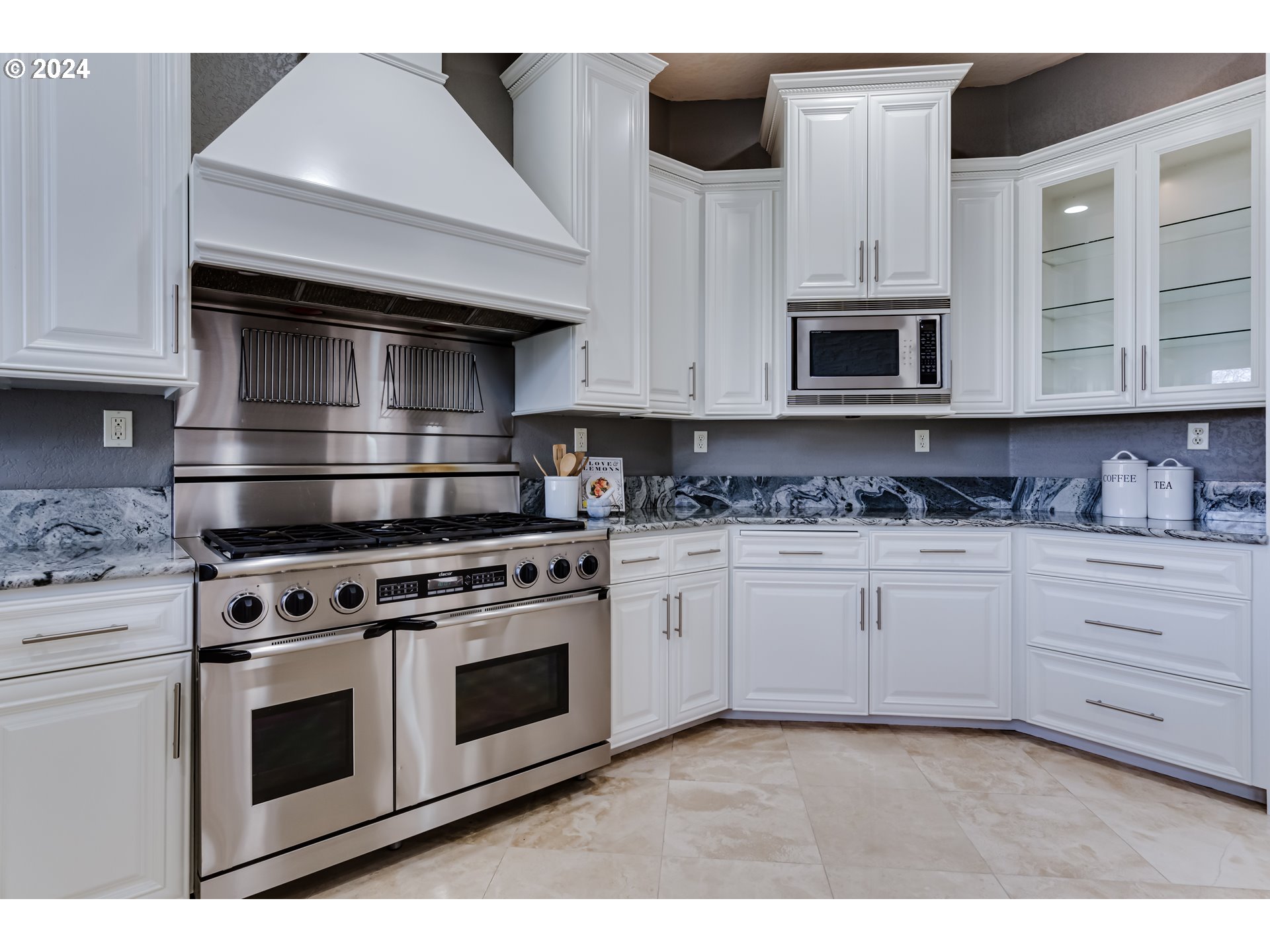3740 Meadow View Drive Eugene, OR 97408 - Photo 13 of 46 a kitchen with stainless steel appliances white cabinets a stove top oven and a granite counter tops