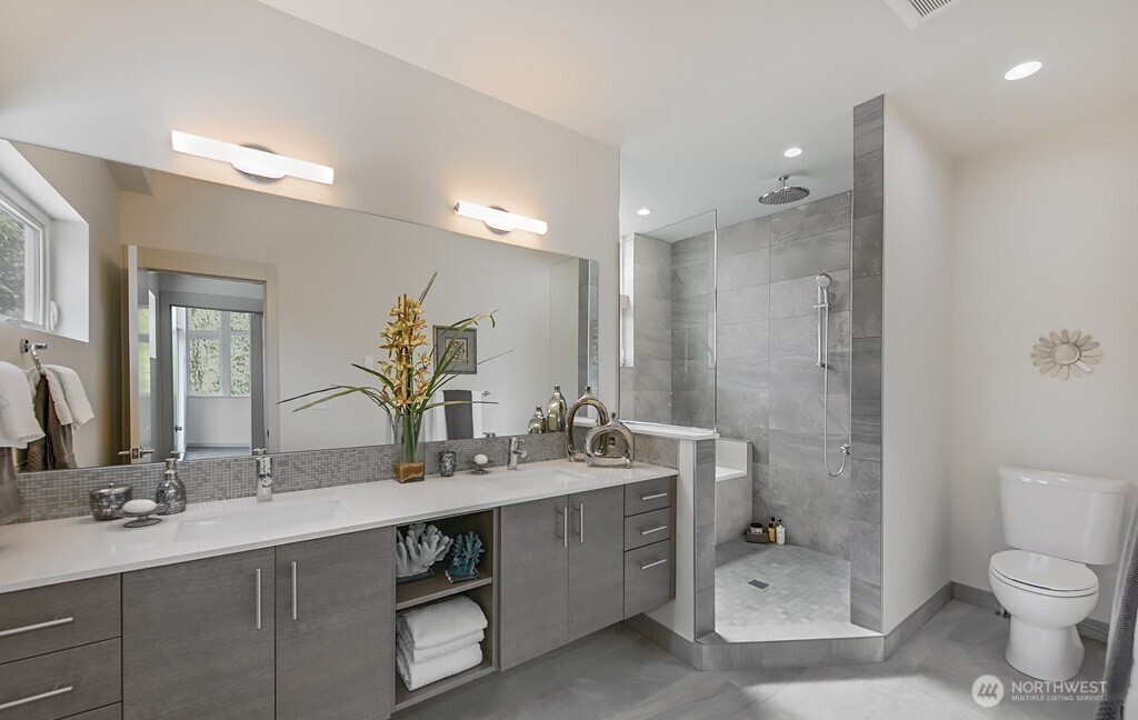 3516 Northeast 87th Street, Unit C Seattle, WA 98115 - Photo 13 of 18 a bathroom with a sink double vanity and a toilet