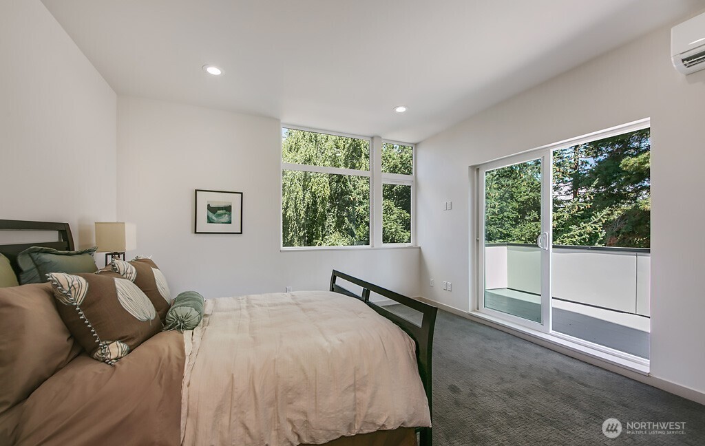 3516 Northeast 87th Street, Unit C Seattle, WA 98115 - Photo 15 of 18 a bed sitting in a bedroom next to a window