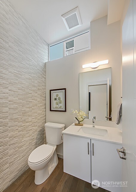 3516 Northeast 87th Street, Unit C Seattle, WA 98115 - Photo 16 of 18 a bathroom with a toilet sink and mirror