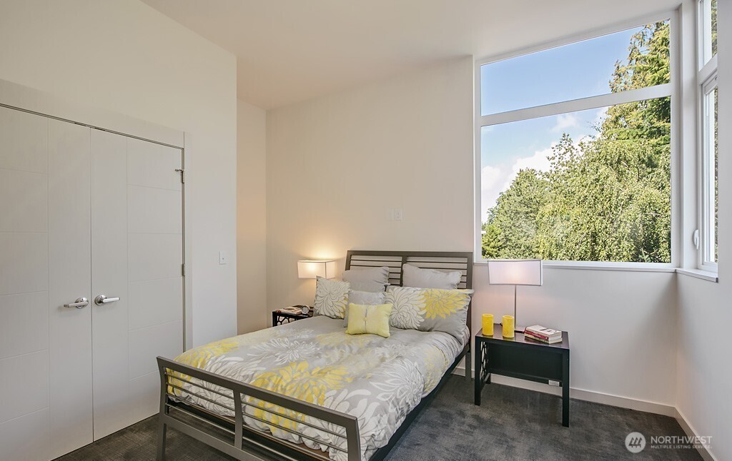 3516 Northeast 87th Street, Unit C Seattle, WA 98115 - Photo 5 of 18 a bedroom with a bed and a window
