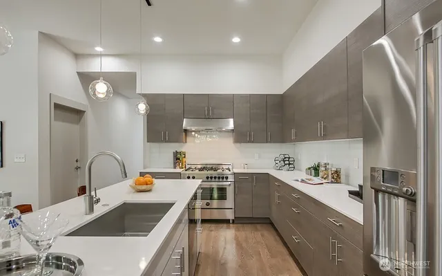 a kitchen with a sink a stove and chairs