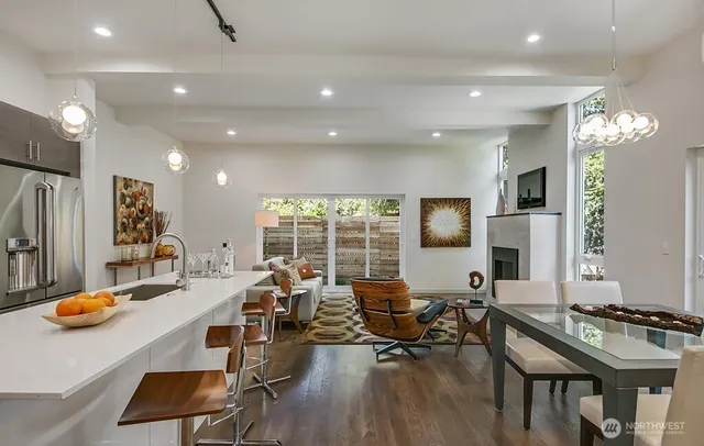 a living room with lots of furniture and kitchen view