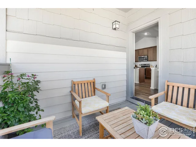 a view of a wooden floor and a bench in the patio