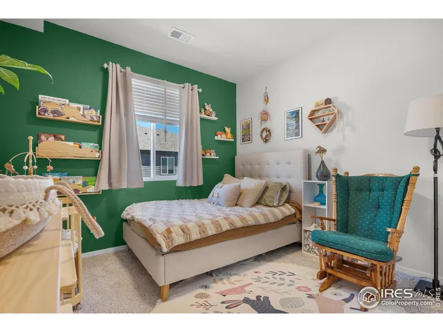 a living room with a bed furniture and a window