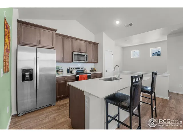 a kitchen with stainless steel appliances a refrigerator sink and stove