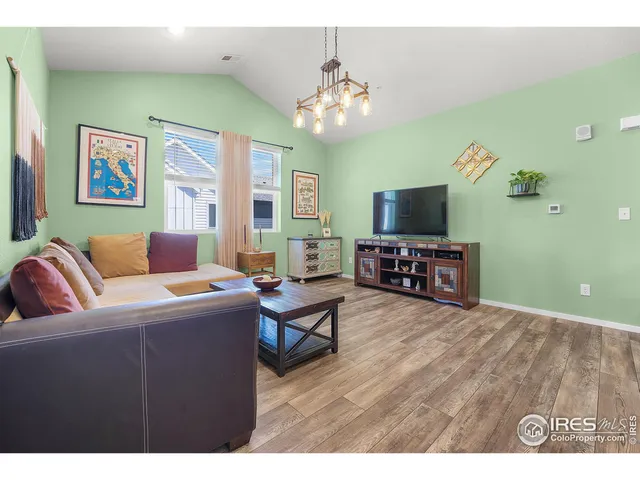 a living room with furniture a large window and a flat screen tv