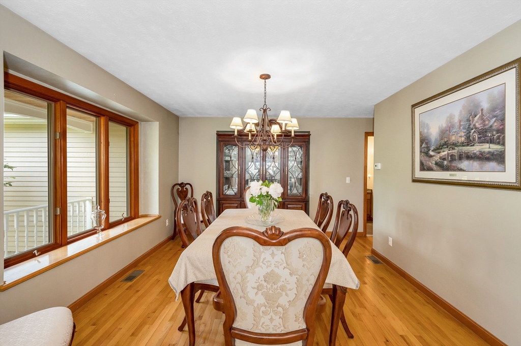 51 Tyler Road Townsend, MA 01469 - Photo 3 of 42 a dining room with furniture a chandelier and wooden floor
