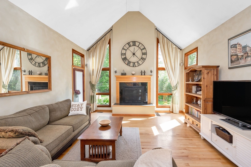 51 Tyler Road Townsend, MA 01469 - Photo 7 of 42 a living room with furniture a flat screen tv and a fireplace