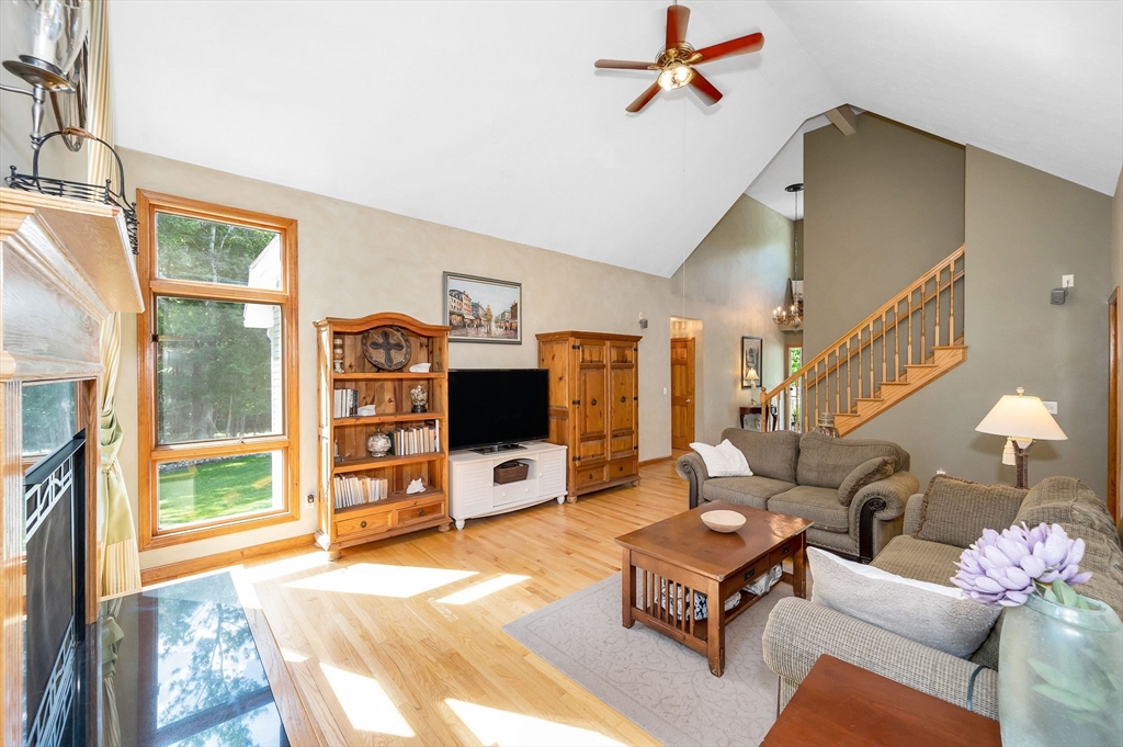 51 Tyler Road Townsend, MA 01469 - Photo 9 of 42 a living room with furniture a flat screen tv and a floor to ceiling window