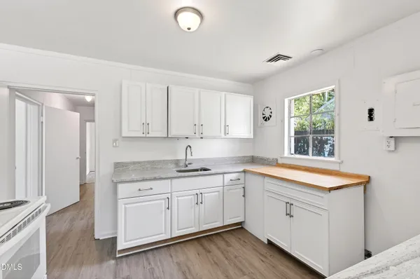 a kitchen with a sink stove and cabinets