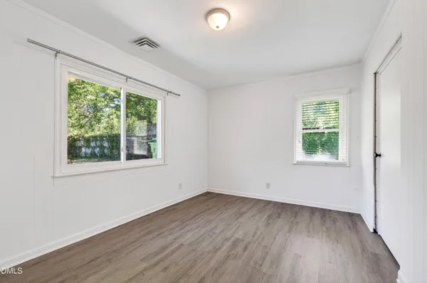 wooden floor in an empty room with a window