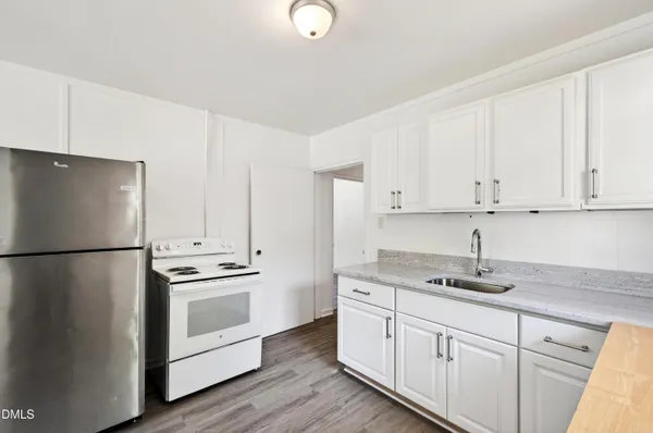 a kitchen with appliances a sink and cabinets