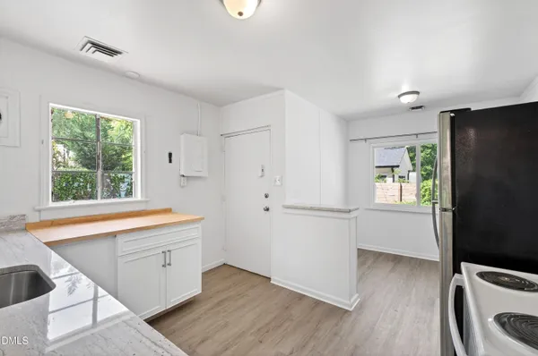 a kitchen with a refrigerator and a sink