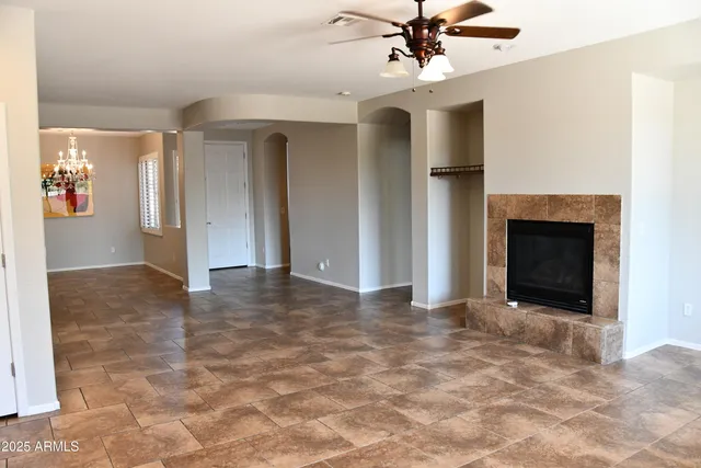 a view of an empty room with a fireplace