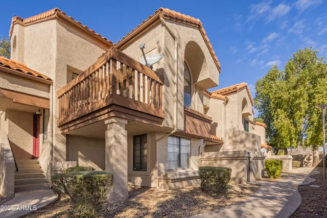 a view of a house with a wrought fence