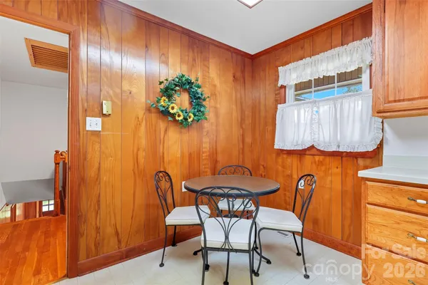 a dining room with furniture and a window