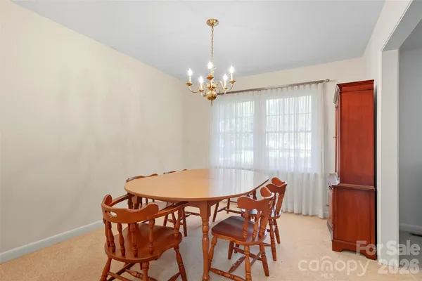 a dining room with furniture and chandelier