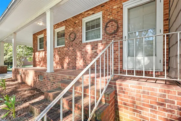 a view of balcony with floor to ceiling windows and wooden floor
