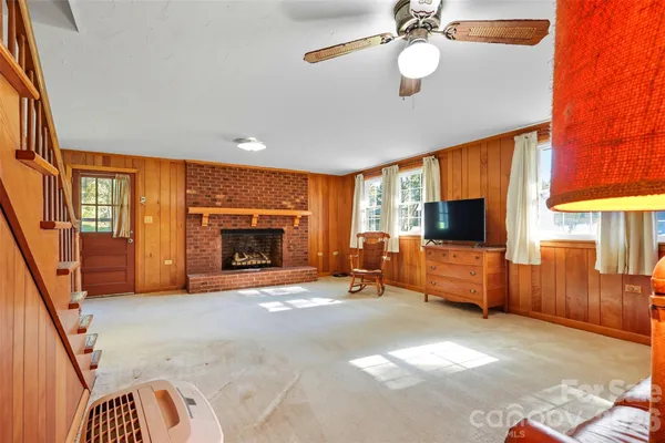 a view of a room with furniture and a window