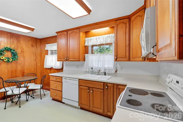 a kitchen with a sink a stove and a refrigerator