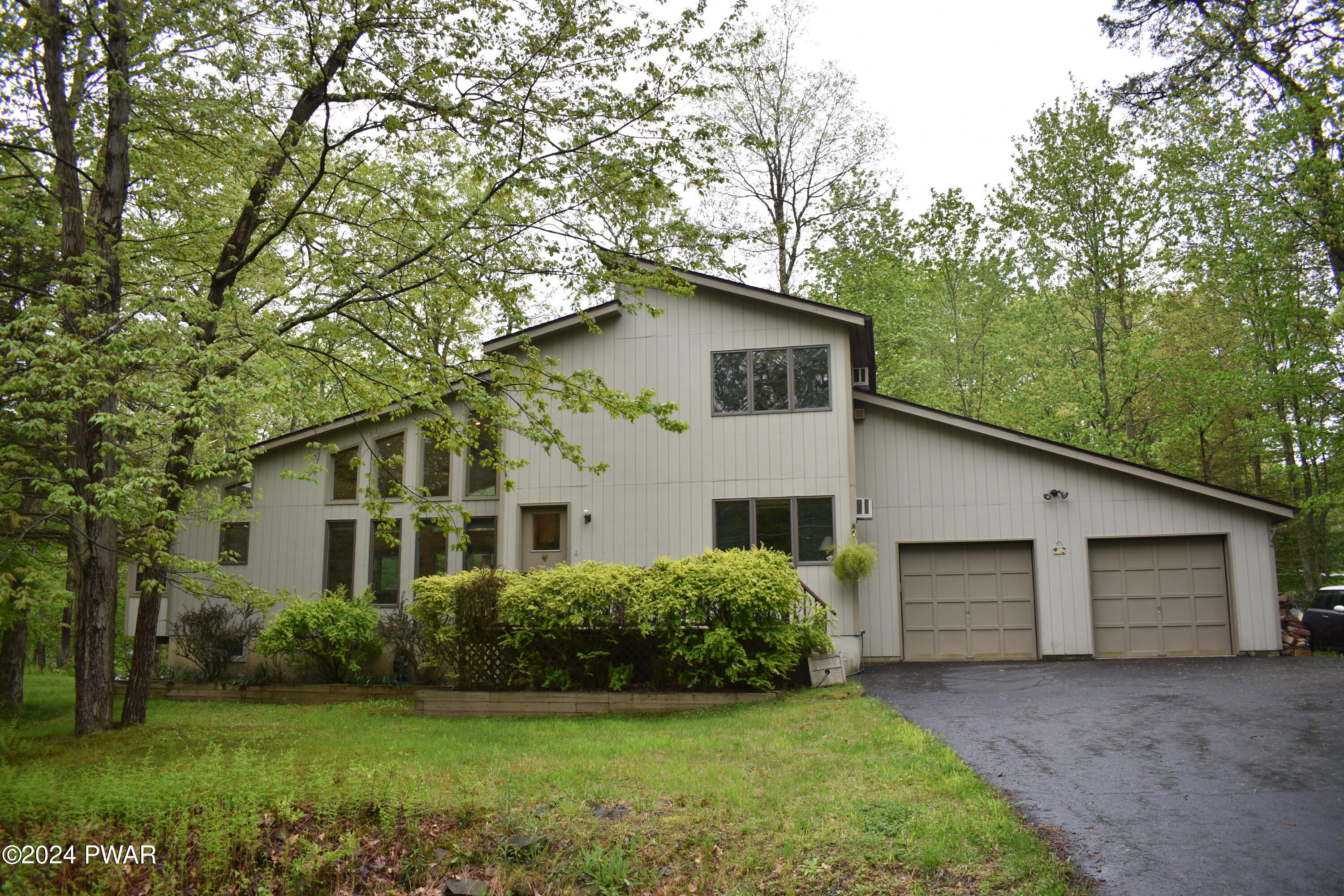 115 Rodeo Lane Hawley, PA 18428 - Photo 1 of 38 a front view of a house with a garden and yard